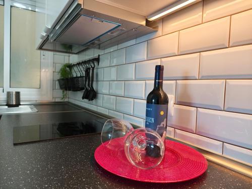 a bottle of wine and a glass on a counter at Sunset living area in Puerto de la Madera