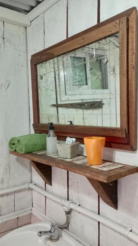 a bathroom with a sink with a mirror and a sink at Cabaña Agustina in El Soberbio