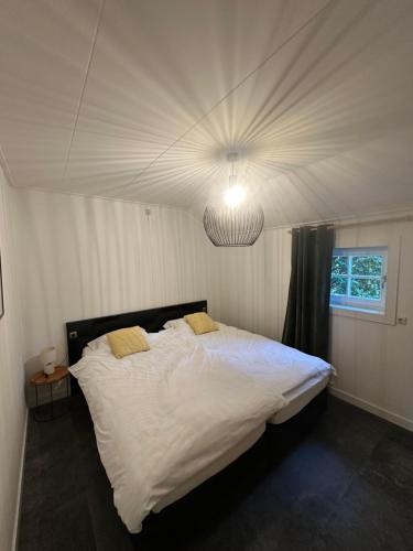 a bedroom with a large white bed with a light at De Schuure 't Voorde in Winterswijk in Winterswijk