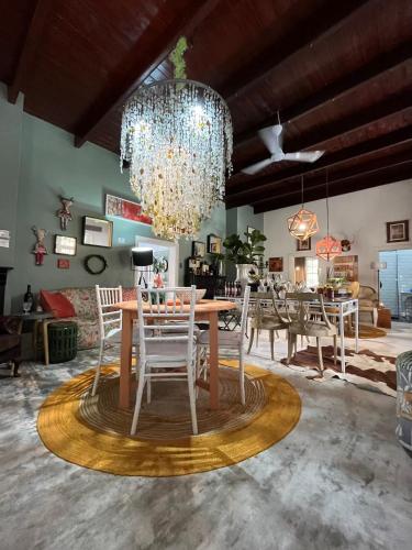 a dining room with a table and chairs and a chandelier at Calitzdorp Self-Catering Guesthouse - Oudehuis in Calitzdorp