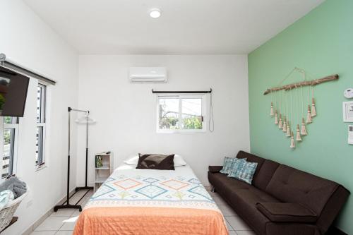 a living room with a bed and a couch at Departamento Palmita in La Paz