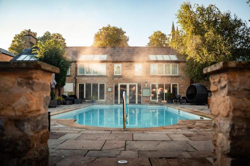 an exterior view of a house with a swimming pool at Feversham Arms Hotel & Verbena Spa in Helmsley