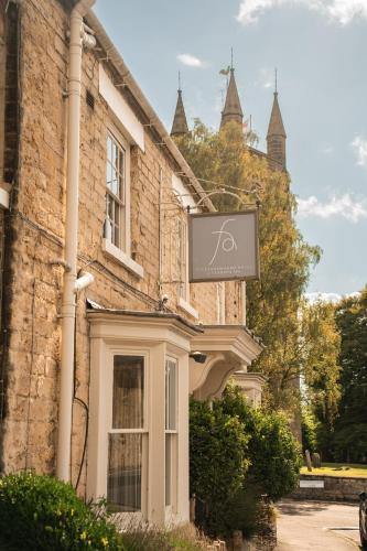a sign on the side of a brick building at Feversham Arms Hotel & Verbena Spa in Helmsley