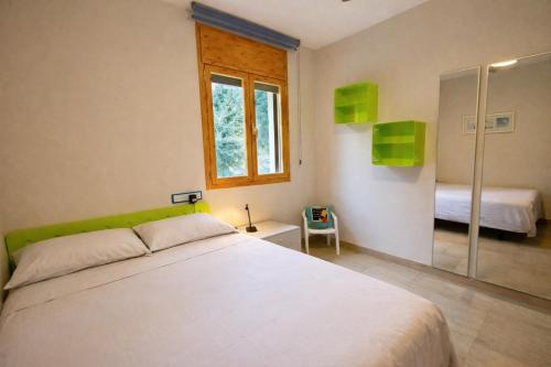 a bedroom with a white bed and a glass shower at Spacious Countryside Costa Brava Relax in Sils
