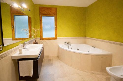 a bathroom with a tub and a sink at Spacious Countryside Costa Brava Relax in Sils