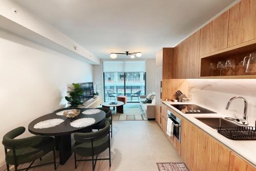a kitchen with a table and some chairs and a sink at Stylish Condo at The Crosby in Miami