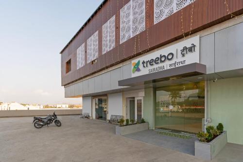 a motorcycle parked in front of a building at Treebo Sairadha in Pune