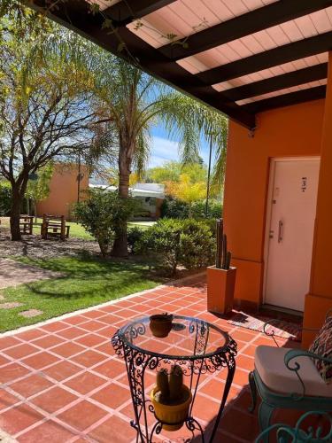 a patio area with a table and a tableablish at Cepas del Valle - cabañas y suites in Chilecito