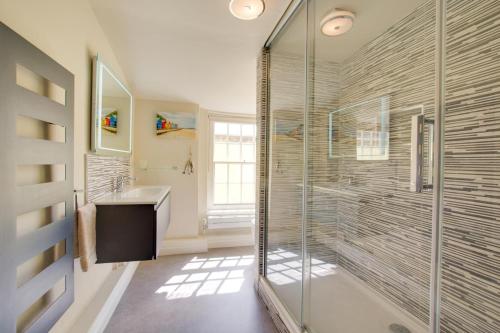 a bathroom with a glass shower and a sink at 4 Bed in Cromer oc-2117 in Cromer