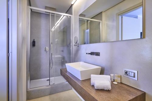 a bathroom with a sink and a shower at Hotel Don Ferrante in Bellagio
