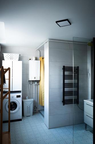 a bathroom with a toilet and a washing machine at Have a Cosy, Élégance in Grand-Fort-Philippe