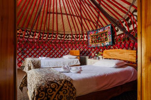 a bedroom with two beds in a yurt at As A Nomad Naryn Ethno Complex in Naryn