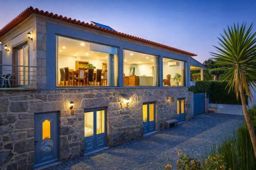 a house with large glass doors and windows at Casa Antigo Alambique in Santa Cruz do Lima