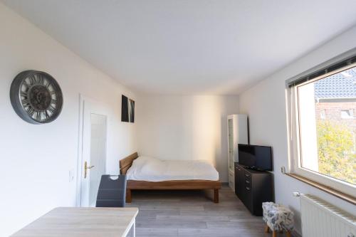 a bedroom with a bed and a window at Exclusive Home Feeling Flat in Ratingen