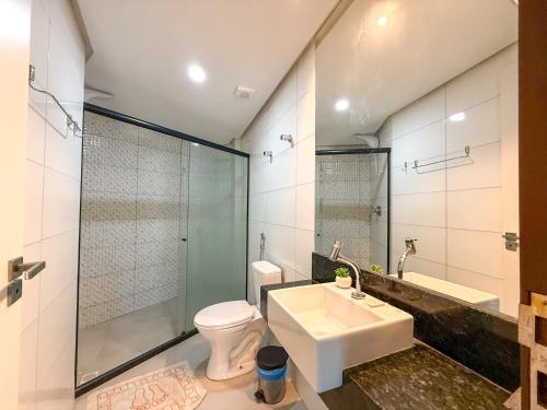 a bathroom with a sink and a toilet and a shower at Hotel JD in Taquaritinga do Norte