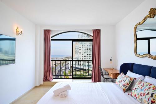 a bedroom with a bed and a large window at (Floor Shelter)Luxury Sea View w/Pool Inside Hotel in Tel Aviv
