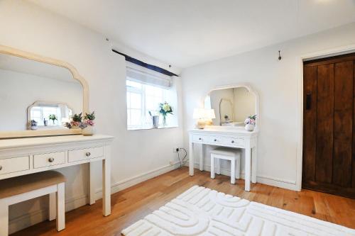 a bathroom with two sinks and a mirror at The Moonraker Hotel in Bradford on Avon