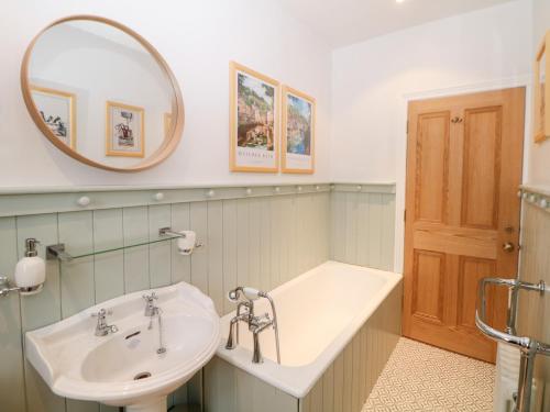 a bathroom with a sink and a mirror at Dorset Villas in Matlock
