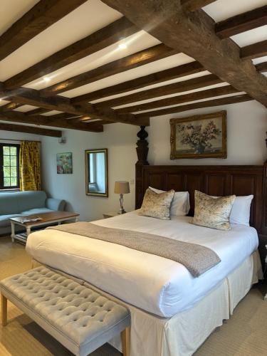 a large bedroom with two beds and a couch at The Moonraker Hotel in Bradford on Avon