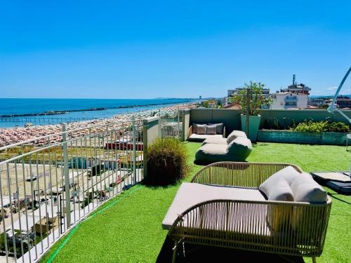 a balcony with benches and a view of the beach at Residence Frontemare in Rimini
