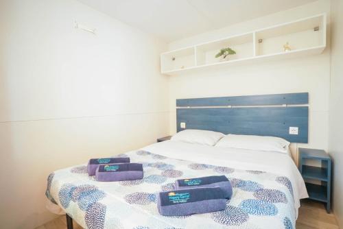 a bedroom with a bed with two towels on it at Camping Bella Austria - Maeva Vacansoleil in Sankt Peter am Kammersberg