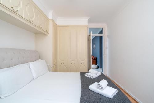 a bedroom with a bed and two towels on the floor at 5-Star 2BE Apt in Central London Perfect 2026 in London