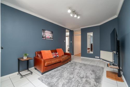 a living room with a brown leather couch and a tv at 5-Star 2BE Apt in Central London Perfect 2026 in London