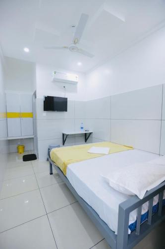a hospital room with a bed and a table at SR Residency in Kollam