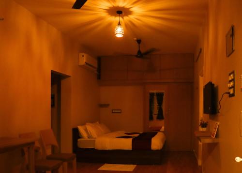 a bedroom with a bed in a room at Le Sara's Nest in Pondicherry