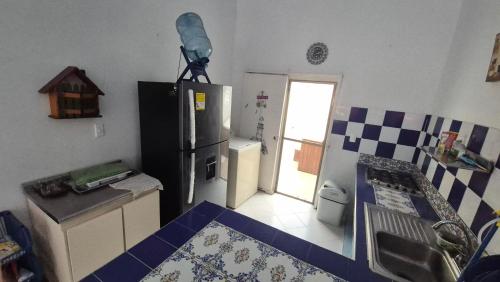 a kitchen with a refrigerator and a table in it at Casa Dante in Melgar