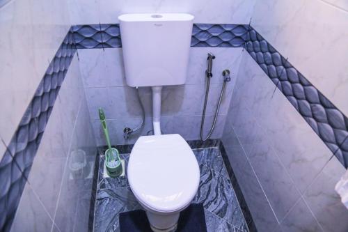 a bathroom with a white toilet in a room at Celesta House in Mbarara