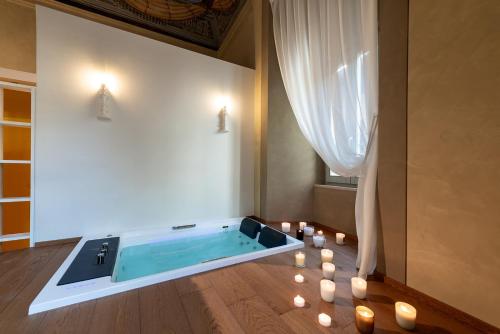 a pool in a room with candles on the floor at Palazzo Sbaraglini in Assisi