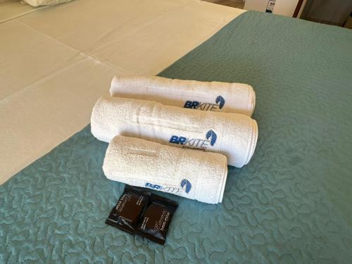 three rolls of toilet paper and a bar of chocolate at BRKITE Pousada in Cumbuco