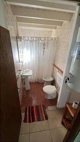 a small bathroom with a toilet and a sink at Complejo La Rosa Molinari Cosquin in Córdoba