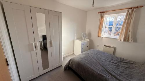 a bedroom with a bed and a sliding door at Double bedroom and private bathroom in the heart of Oxford in Oxford