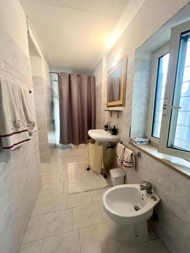 a bathroom with a sink and a toilet at Al Castello - UN LETTO IDEALE in Gaeta