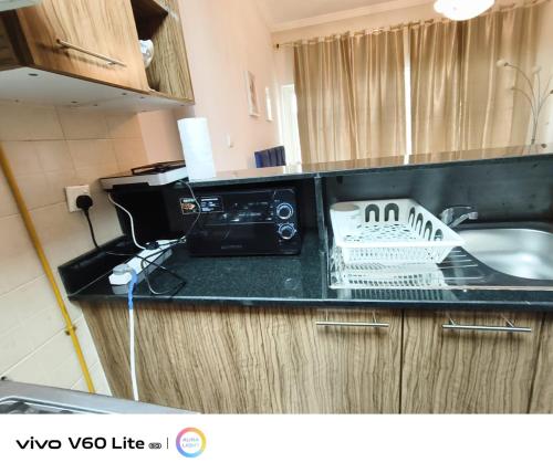 a kitchen counter with a sink and a microwave at Downtown Dubai Mall walk & Burj Khalifa DIFC 5 mins in Dubai
