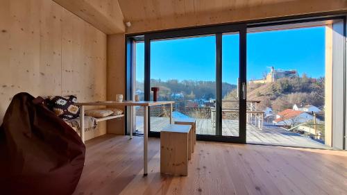 a room with a table and a large window at mini mal anders in Altmannstein