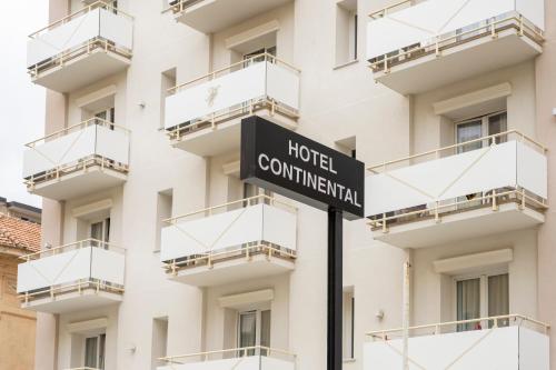 a street sign in front of a building at Hotel Continental in Pietra Ligure