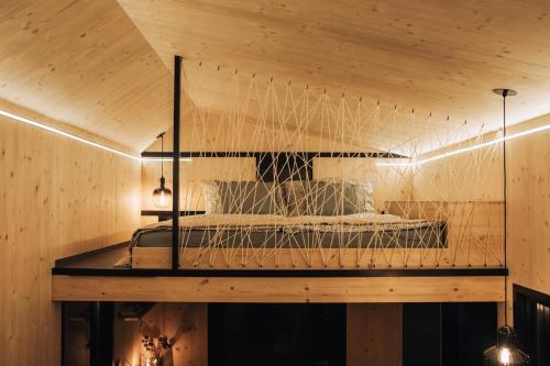 a bird cage in a room with a wooden ceiling at Rusty Cabin -Tiny House in Neustift an der Lafnitz