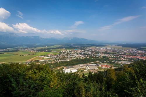 an aerial view of a town with mountains in the background at Hotel Bellevue in Kranj