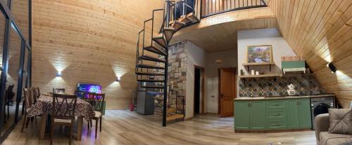 a living room with a spiral staircase in a house at A-frame , Quba Qecres in Qǝçrǝş