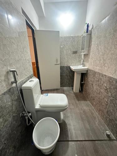 a bathroom with a toilet and a sink at The Golden Attic in Yangang