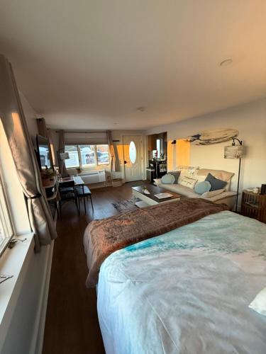 a bedroom with two beds and a living room at Pet friendly waterfront condo in Edgecomb