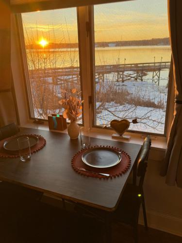 a table with a view of a pier from a window at Pet friendly waterfront condo in Edgecomb