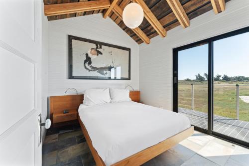a bedroom with a bed and a large window at Bodega Bay - Ocean View, Fireplace & BBQ in Bodega Bay