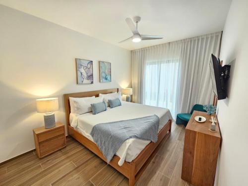 a bedroom with a bed and a ceiling fan at Cana Cove in Punta Cana