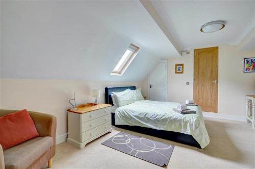 a bedroom with a bed with a dresser and a couch at 2 Bed in Lynton oc-chap in Lynmouth