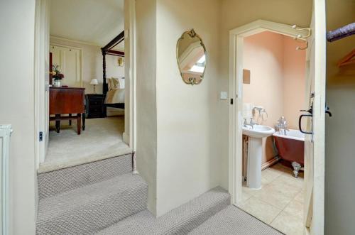 a bathroom with a tub and a sink and a mirror at 4 Bed in Parracombe oc-laurel in Parracombe