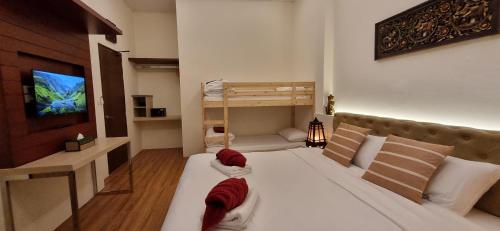 a bedroom with two beds and a tv and a bunk bed at Sila Thai Pool Villa3 in Ao Nang Beach